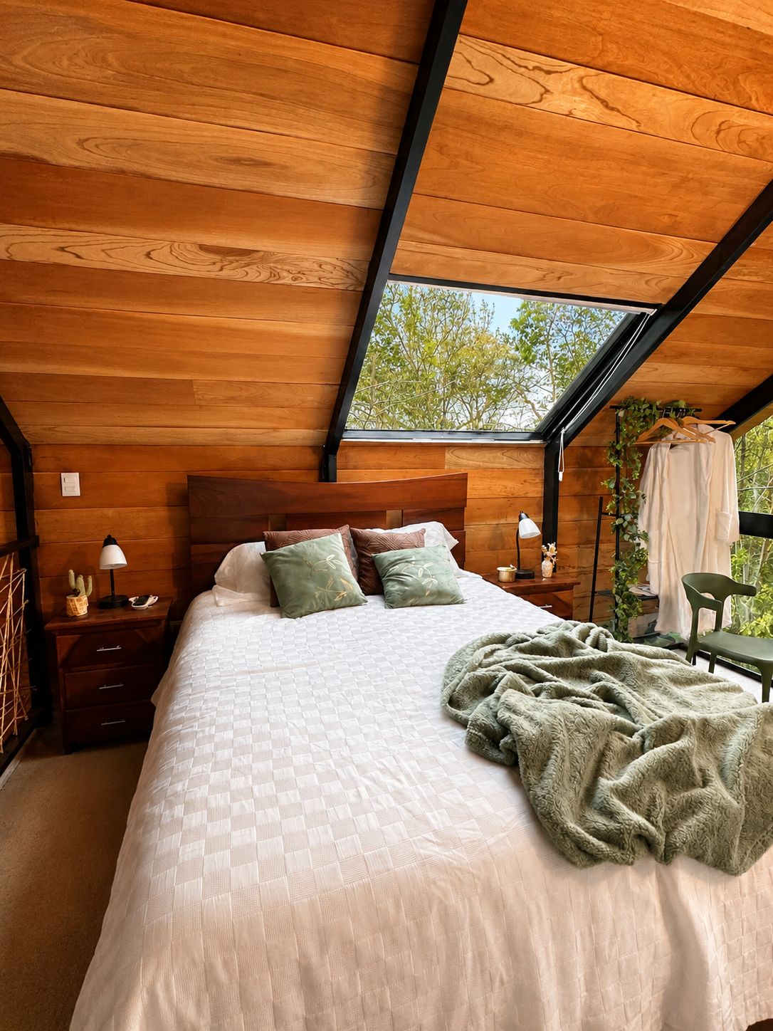 Habitación con cama king y tragaluz al bosque